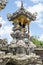 Balinese Hindu family shrine or temple ornately covered with gold showing many effigies of gods and demons.