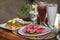 Balinese lunch served on a table with noodles, watermelon and colourful smoothie decoration