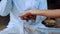 Balinese priest taking woman hand to do palm reading