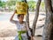 Balinese woman carrying blessing canang trays on her head