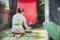 Balinese woman doing ritual offering canang sari and praying at