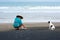 Balinese woman on a volcanic Beach making daily nature-based worship of Balinese Hinduism. Canggu, Bali, Indonesi,02 October 2016