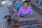 Balinese women work in an open weaving workshop on looms. Processing of hand-dyed cotton fibers. Workers work in a loom house.