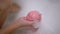 Ball of Bathroom Salt Dissolves in Foam Water, in Hands Child. Slow-motion.