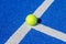 ball on a blue paddle tennis court line
