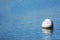 Ball buoy floats on a calm water surface