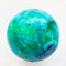ball from Chrysocolla gemstone on white marble