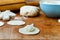 Ball of dough, and small pieces of rolled tortillas for dumplings with cottage cheese on a kitchen wooden board