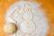 A ball of dough and a snowman drawing of flour on a wooden Board