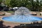 Ball-fountain surrounded by greenery in a park under sunlight in Naperville in Illinois