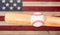 Ball hitting wooden bat with faded boards painted in American US