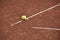 Ball on the line on tennis clay court