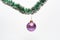 Ball with ornaments hang on shimmering green tinsel. Decoration for Christmas tree hang on tinsel. Christmas decorations