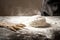 Ball of raw dough isolated on white wooden table with ears wheat. Copy space