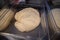 Ball of raw uncooked swiss zopf bread dough rising in a plastic container