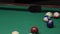 The ball is scored in the pocket. Sports game of billiards on a green cloth. Billiard balls with numbers on the billiard table