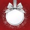 Ball with silver satin ribbon bow on red background