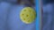 Ball spinning on a pickleball racket in pickler\'s hand in slow motion