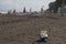 Ball and swimming glasses on beach. Blurred photo of people on sand beach. Travel or sea vacations concept