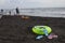 Ball, swimming glasses, sandal, sunbeds and two Floating Ring on beach. Blurred people on sand beach. In the summer vacation