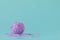 Ball of yarn on aquamarine background