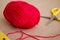 Ball of yarn. A ball of red thread. A ball of thread and scissors. Edge cotton threads