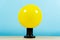 Ball of yellow rubber inflatable edison, on a blue background. Creative idea