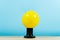 Ball of yellow rubber inflatable edison, on a blue background. Creative idea