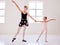 Ballerina, ballet and dance teacher with a child teaching beautiful, elegant and classical choreography in studio. Woman