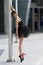 Ballerina in black tutu near a pole