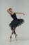 ballerina in a black tutu shows elements of ballet dance in motion