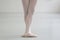 Ballerina with crossed feets standing