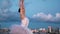 Ballerina dance ballet background city with clouds. Elegant flexible girl dancer