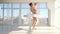 Ballerina dancer standing on tiptoe and holding on hands her little daughter