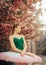 Ballerina dancing against the background of flowering sakura trees and falling petals