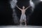 Ballerina dancing in studio with white flour