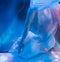 Ballerina dancing underwater in pointe and waved dress, soft  blurred focus in water