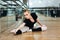 Ballerina doing stretching exercises in ballet class