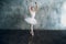 Ballerina female. Young beautiful woman ballet dancer, dressed in professional outfit, pointe shoes and white tutu.