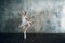 Ballerina female. Young beautiful woman ballet dancer, dressed in professional outfit, pointe shoes and white tutu.