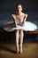 Ballerina holding pearl necklace and smiling