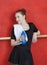Ballerina Holding Waterbottle Against Red Wall