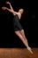 Ballerina Leaping in Studio on Black Background