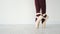 Ballerina legs in beige pointe shoes