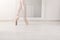 Ballerina in pointe shoes, graceful legs, ballet background