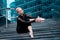 Ballerina puts on pointe shoes. Sitting on stairs, steps