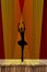 Ballerina silhouette of young dancing elegant ballet girl on pointe shoes on stage in the spotlights with a red curtain background