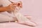 Ballerina sit down on floor to put on slippers prepare for perf