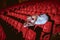 Ballerina sitting in the empty auditorium theater