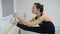 Ballerina stretches herself near barre in the classroom, beautiful women practicing ballet